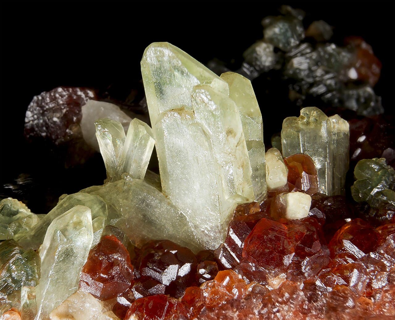 Pale green prismatic diopside crystals on a rock matrix.