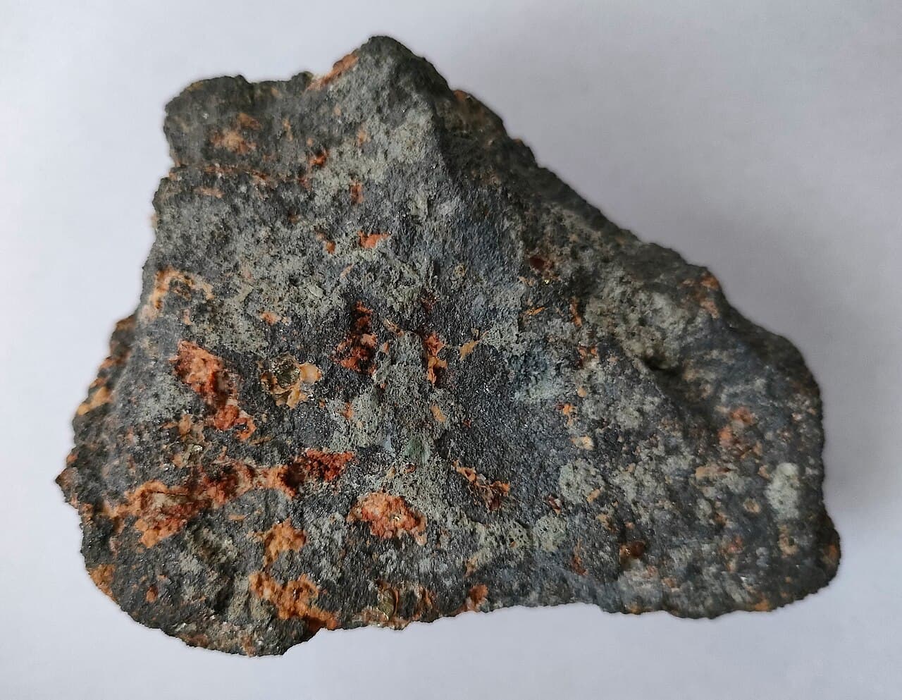 Black metallic magnetite crystals set among white calcite.