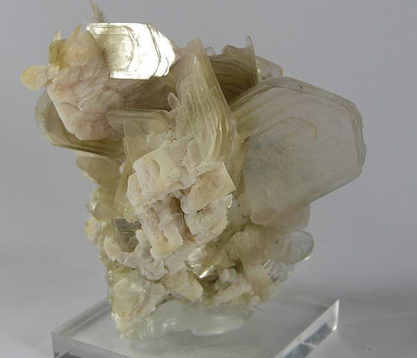Silvery platy muscovite crystals intergrown with white blocky albite.